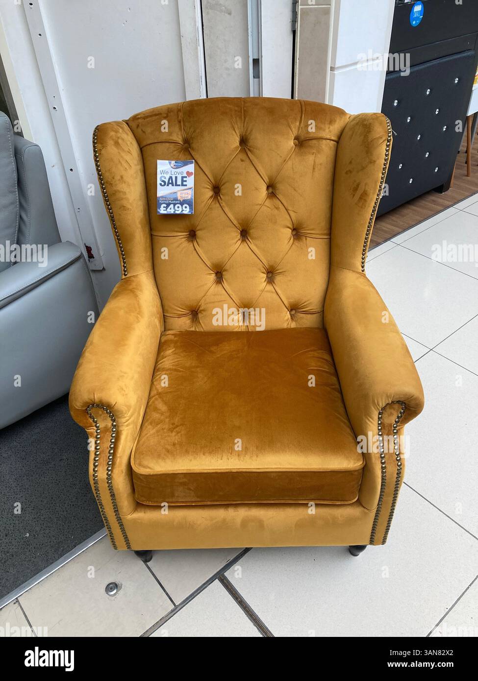 Comfy wingback armchair discounted for sale - Smartphone Captured Stock Image
