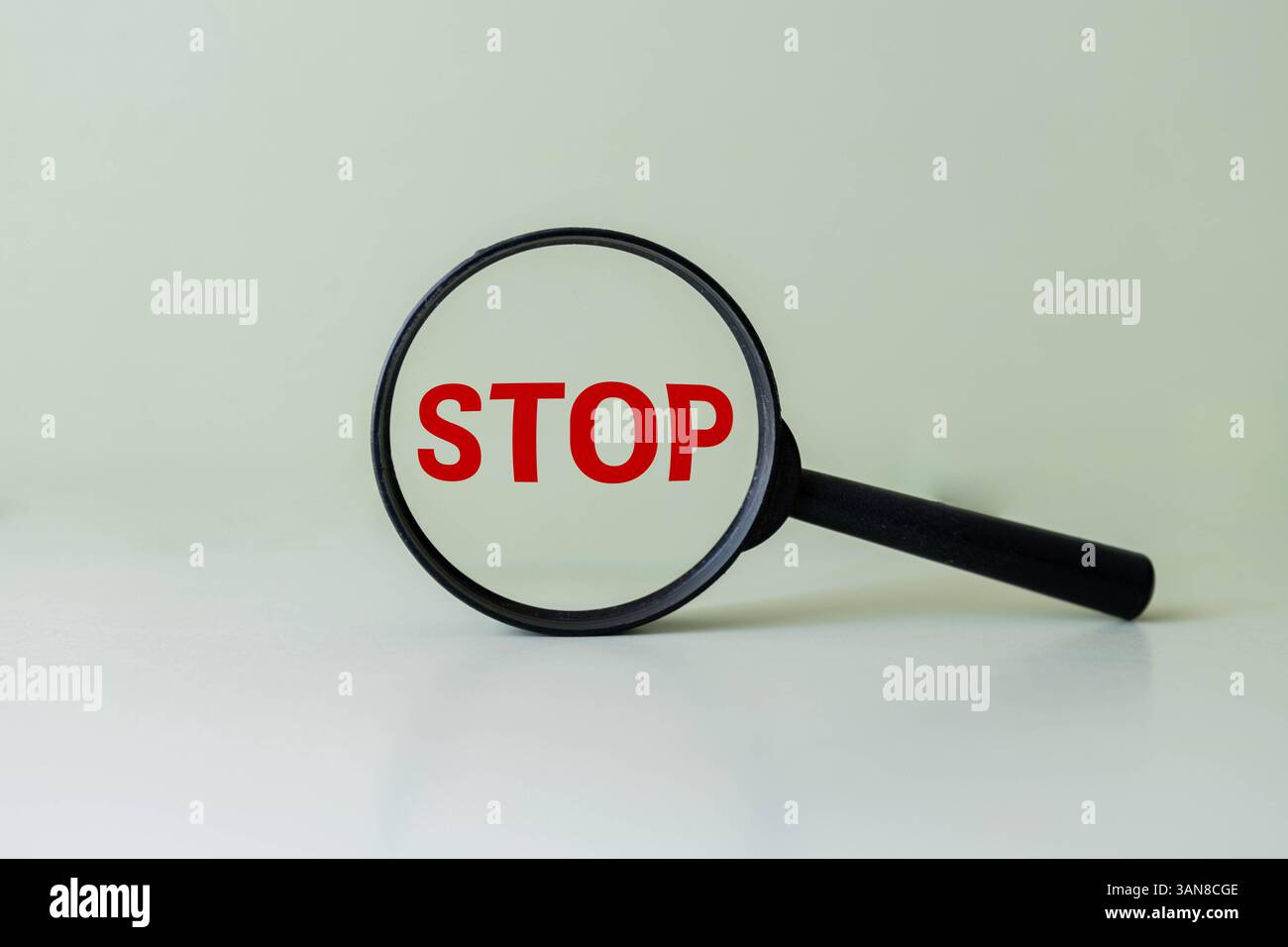 Red stop sign icon under magnifying glass symbolizing caution concept ...