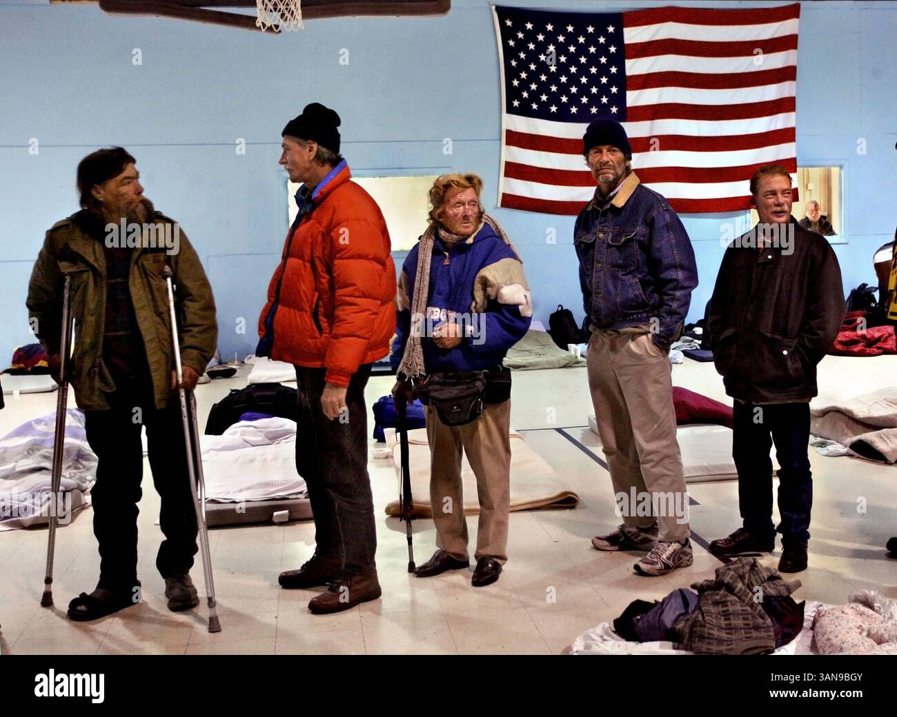 Jan. 07, 2010 - St. Petersburg, Florida, USA - CHERIE DIEZ   |   Times.SP 317246 DIEZ homeless  1 of 5(01/12/2010 PINELLAS PARK) Homeless men wait in food line at cold weather shelter set up at Boys & Girls Club. From left, Tom ''Renegade'' Blanton, 51, said he's been homeless since he lost his job nine years ago and his wife kicked him out. When weather is good he's got permission from a trucking company owner to sleep in a truck sleeper cab parked at the business. Robert Scott, 57, homeless since he lost his job two years ago, has a bachelor's degree. In the last few months he's been in two Stock Photo