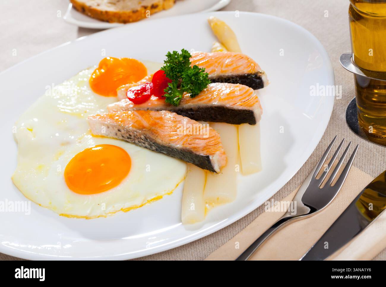 Fried salmon with scrambled eggs and asparagus Stock Photo