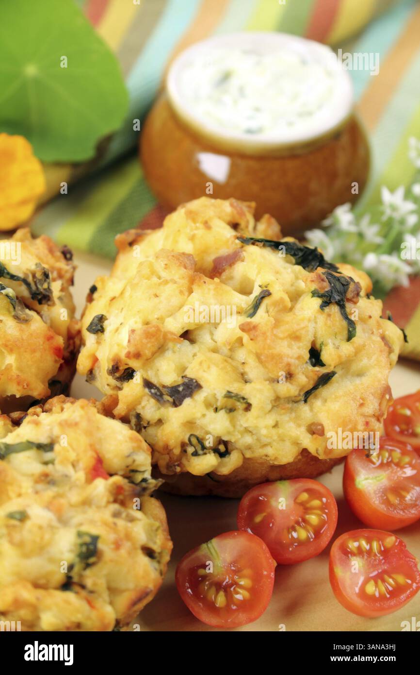 Fresh baked savory muffins with herb spread and cherry tomatoes Stock Photo