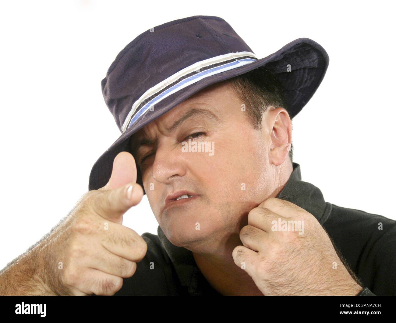 Confident man in hat looking at camera and pointing Stock Photo