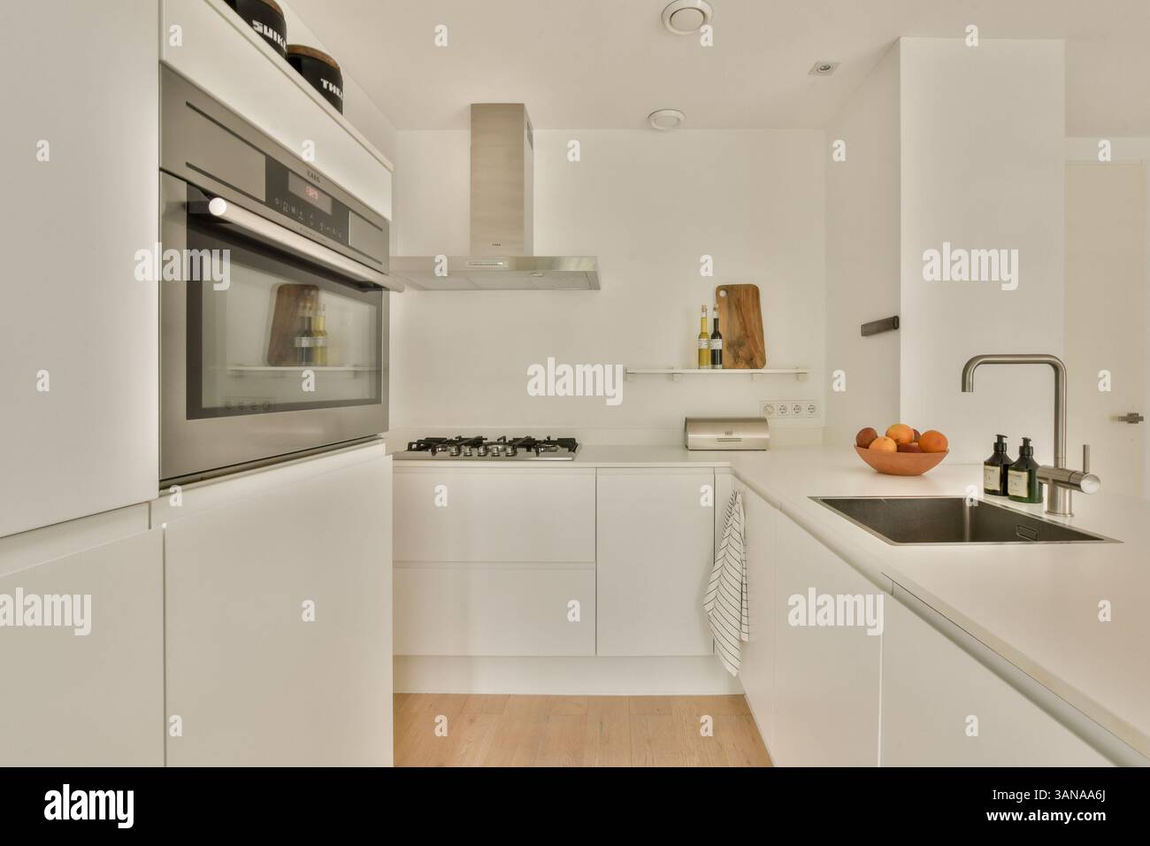A sleek and modern kitchen showcasing minimalistic design with white ...