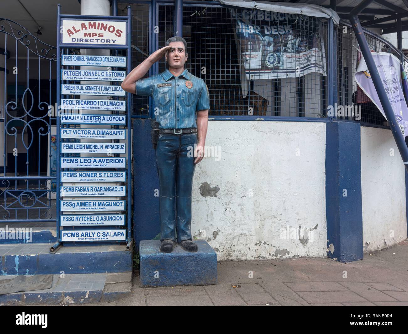Alaminos MPS (Municipal Police Station), Laguna provincial office, statue of an uniformed officer standing at attention & name of local officers - Smartphone Captured Stock Image