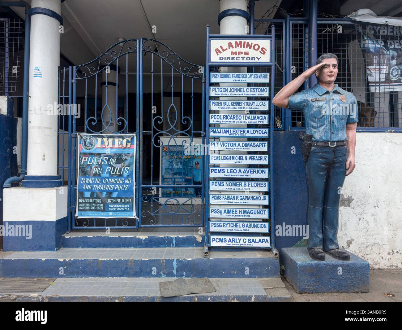 Alaminos MPS (Municipal Police Station), Laguna provincial office, statue of an uniformed officer standing at attention & name of local officers - Smartphone Captured Stock Image