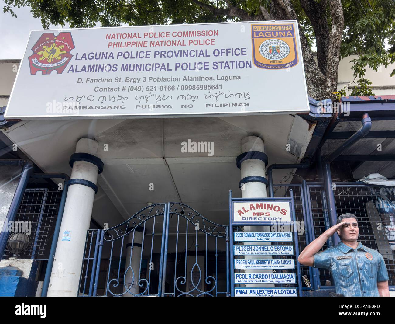 Alaminos MPS (Municipal Police Station), Laguna provincial office, statue of uniformed officer, Baybayin translation (pre-Hispanic Philippine script) - Smartphone Captured Stock Image