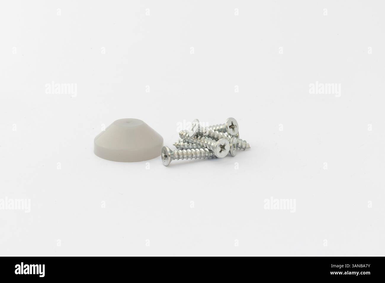 Mixed screws and plastic cap on isolated white background Stock Photo