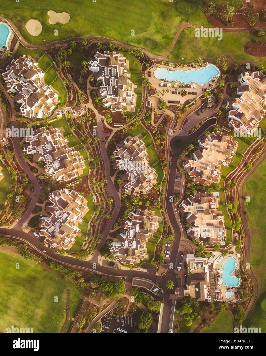 Aerial view of Abama Garden Resort with luxurious pools and golf course surrounded by tropical gardens, Guia de Isora, Spain. Stock Photo