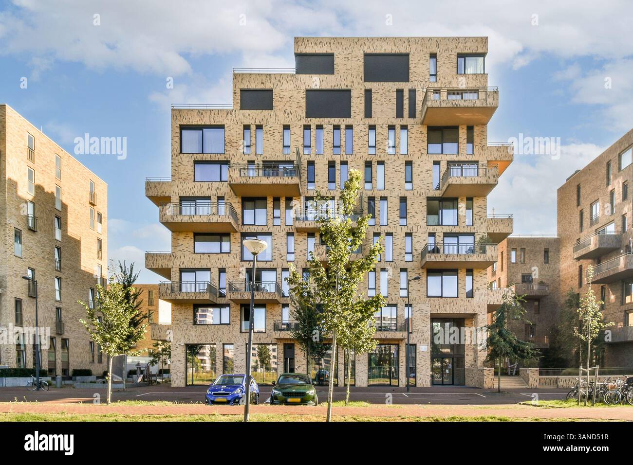 A uniquely designed modern apartment building features a textured ...