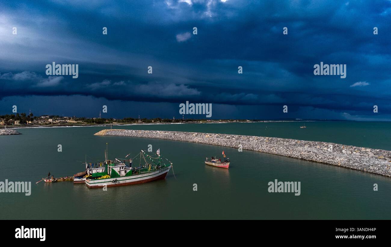 Aerial view of fishing boats in a stormy ocean under dark clouds ...