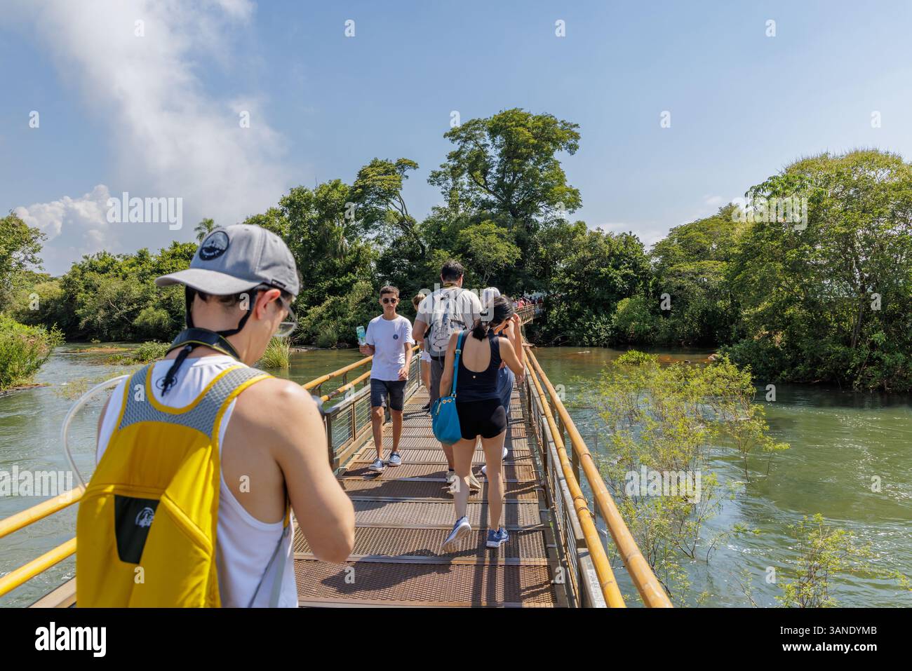 Puerto Iguazu, Misiones, Argentina - April 5th, 2025: Tourists trucking along the Iguazu Falls walkways. Stock Photo