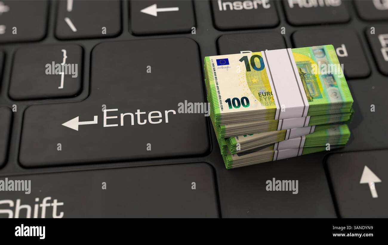 Euro notes lying on PC keyboard Stock Photo