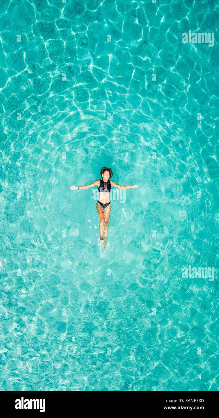 Aerial view of a woman floating in the sea of Ithaca island Stock Photo ...