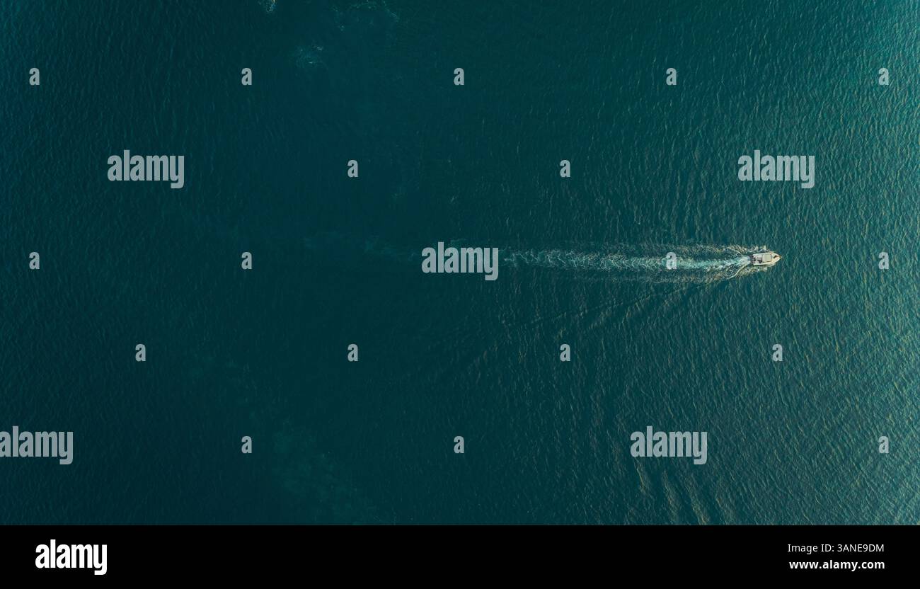 Aerial view of a small motorboat speeding in the mediterranean sea ...
