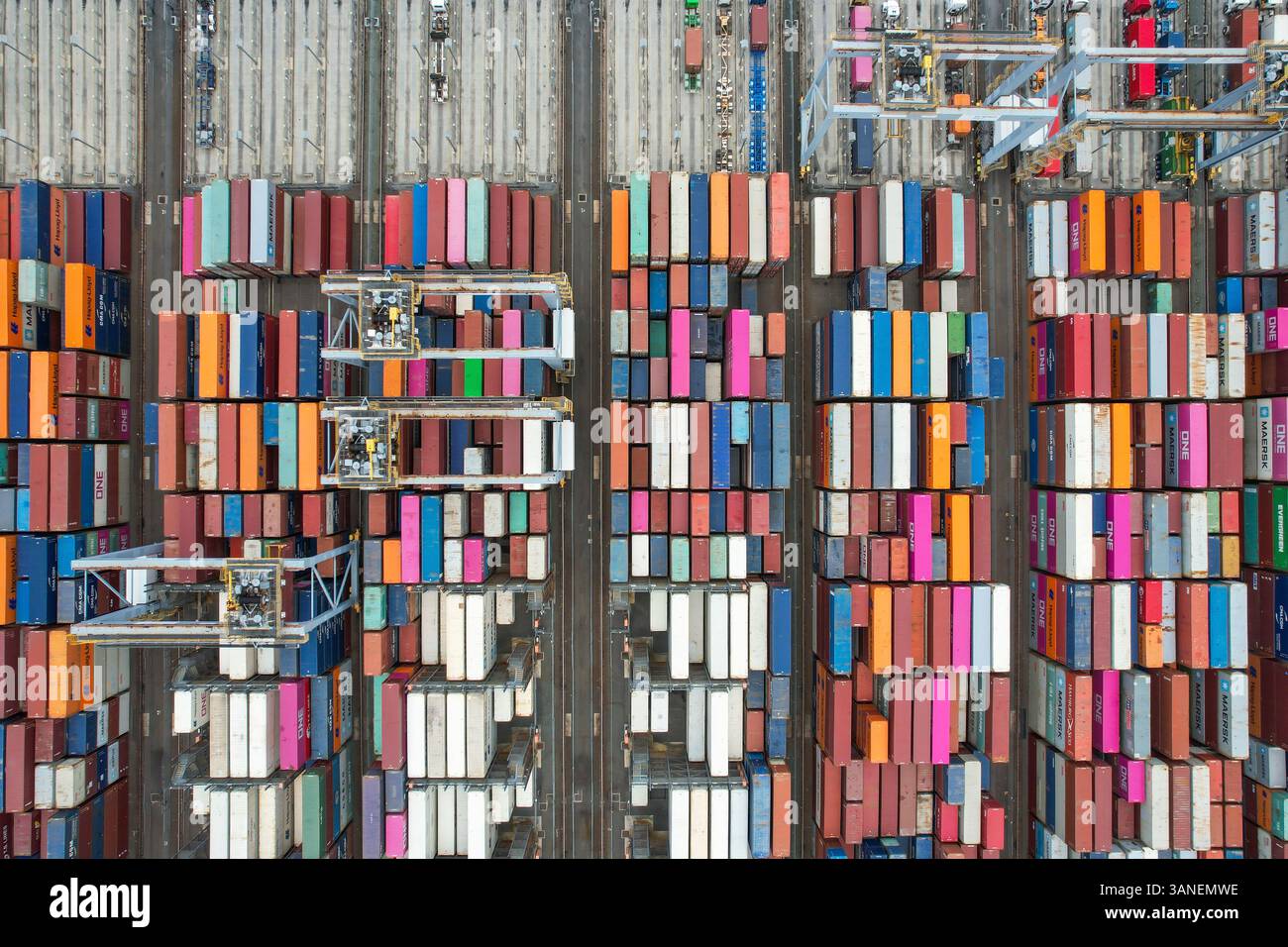 Aerial view of colorful container terminal with cranes and stacked ...