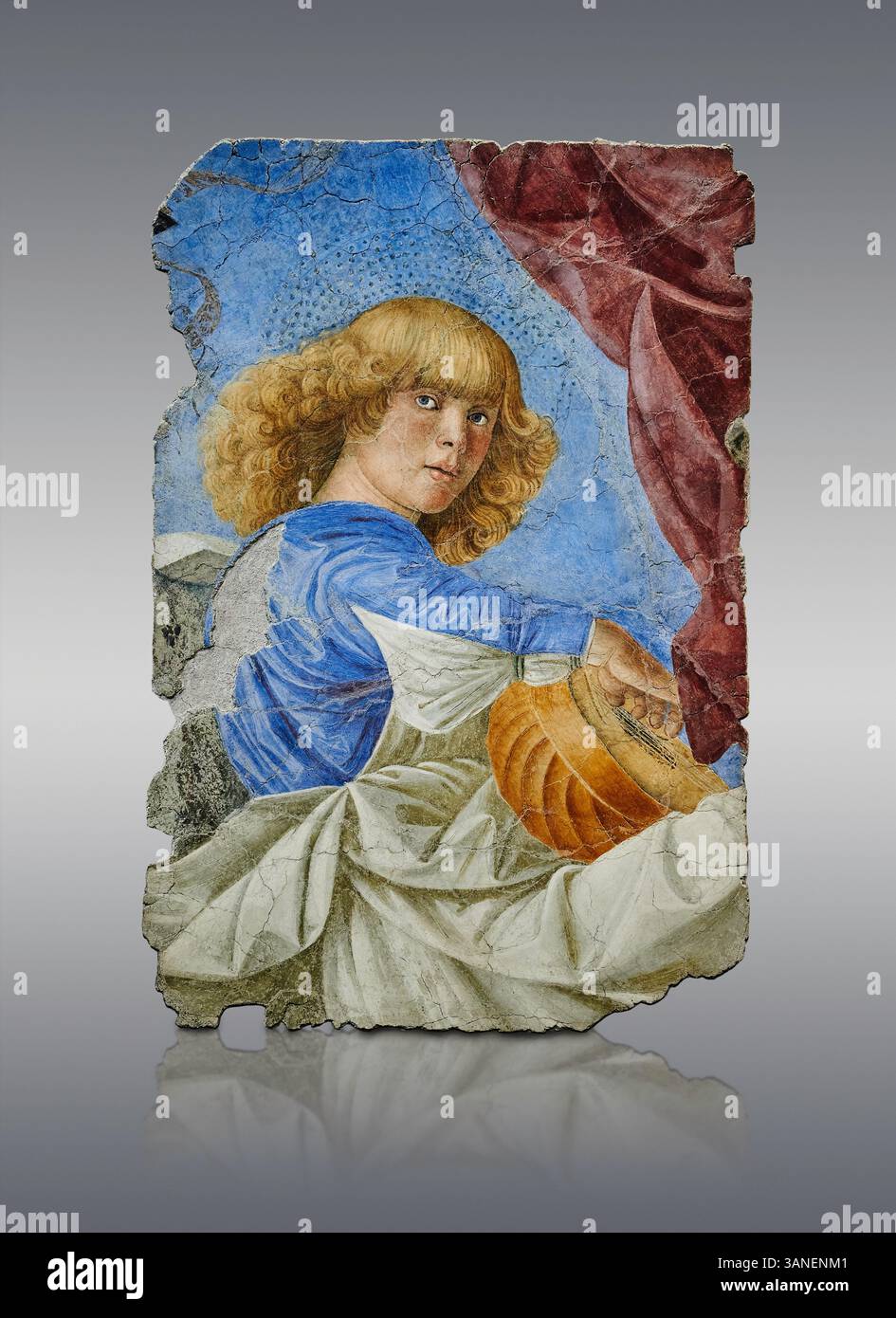 Fragment of a Renaissance apse ceiling fresco depicting a young angel young man paling a loot with Renaissance style clothes & hair. removed from the Stock Photo