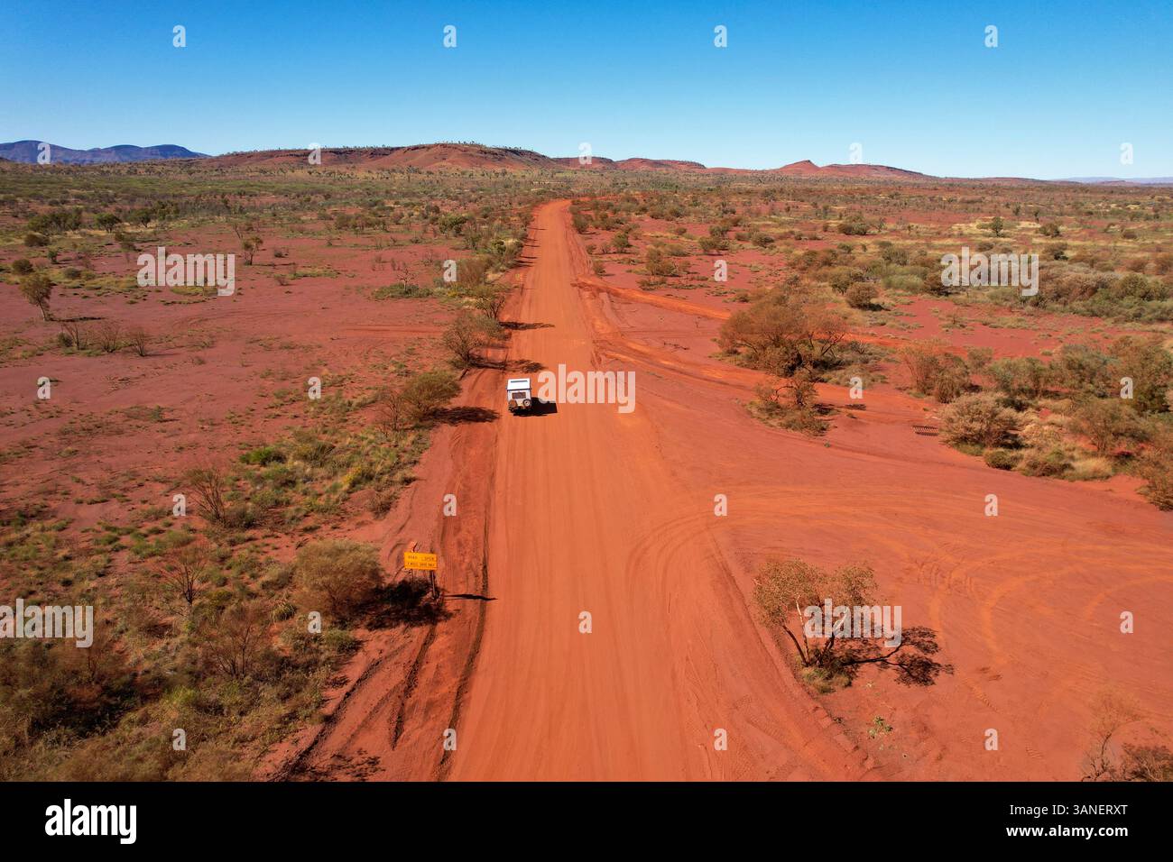 Aerial view of Nanutarra Munjina Road with a campervan in the arid landscape of Karijini National Park, Tom Price, Australia. Stock Photo