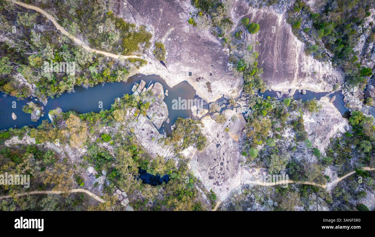 Aerial view of untouched wilderness with creek, rock formations, and ...