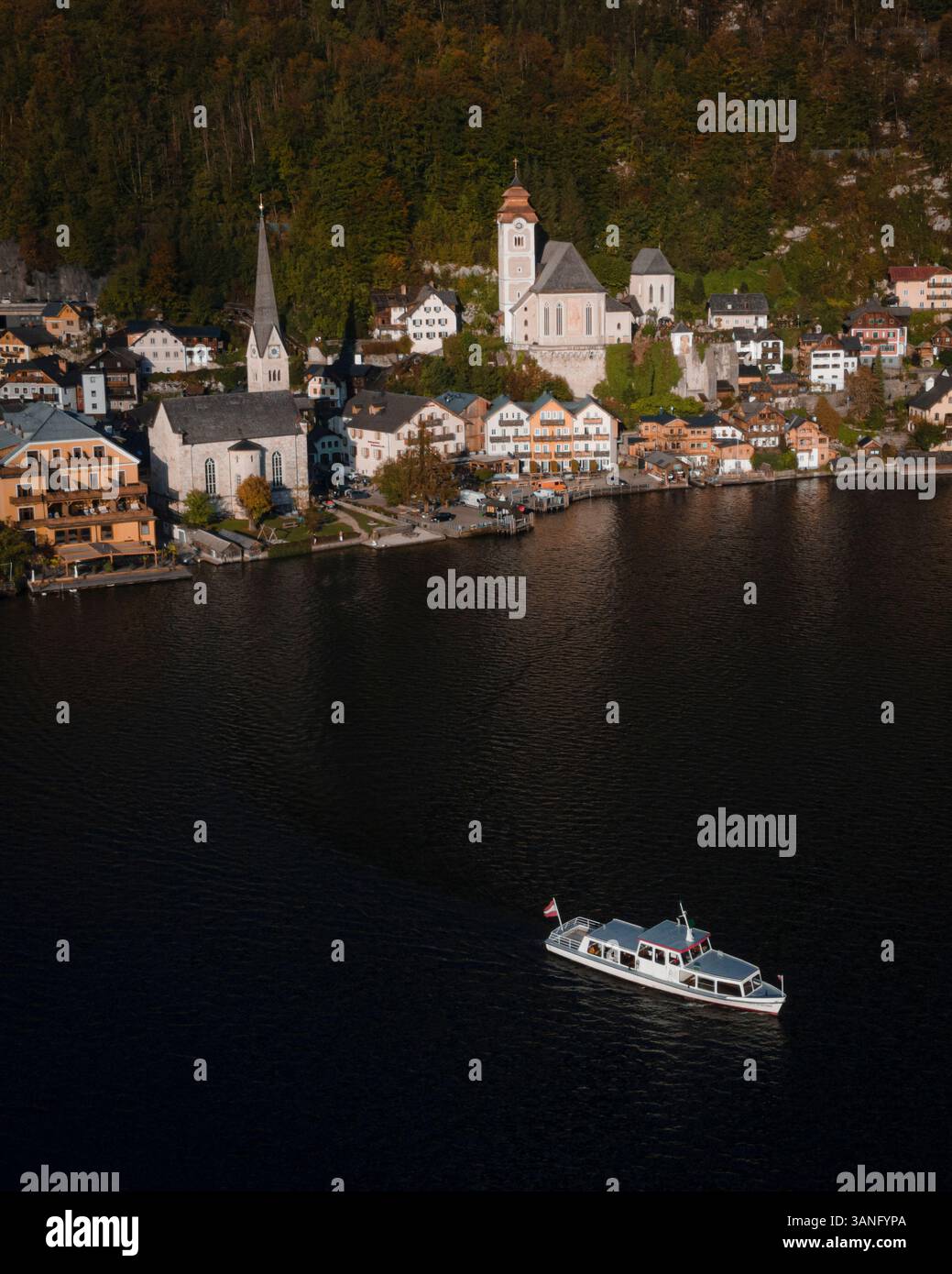 Aerial view of the picturesque town of Hallstatt by the serene Hallstattersee lake at sunrise with charming boats and mountains, Upper Austria, Austri Stock Photo