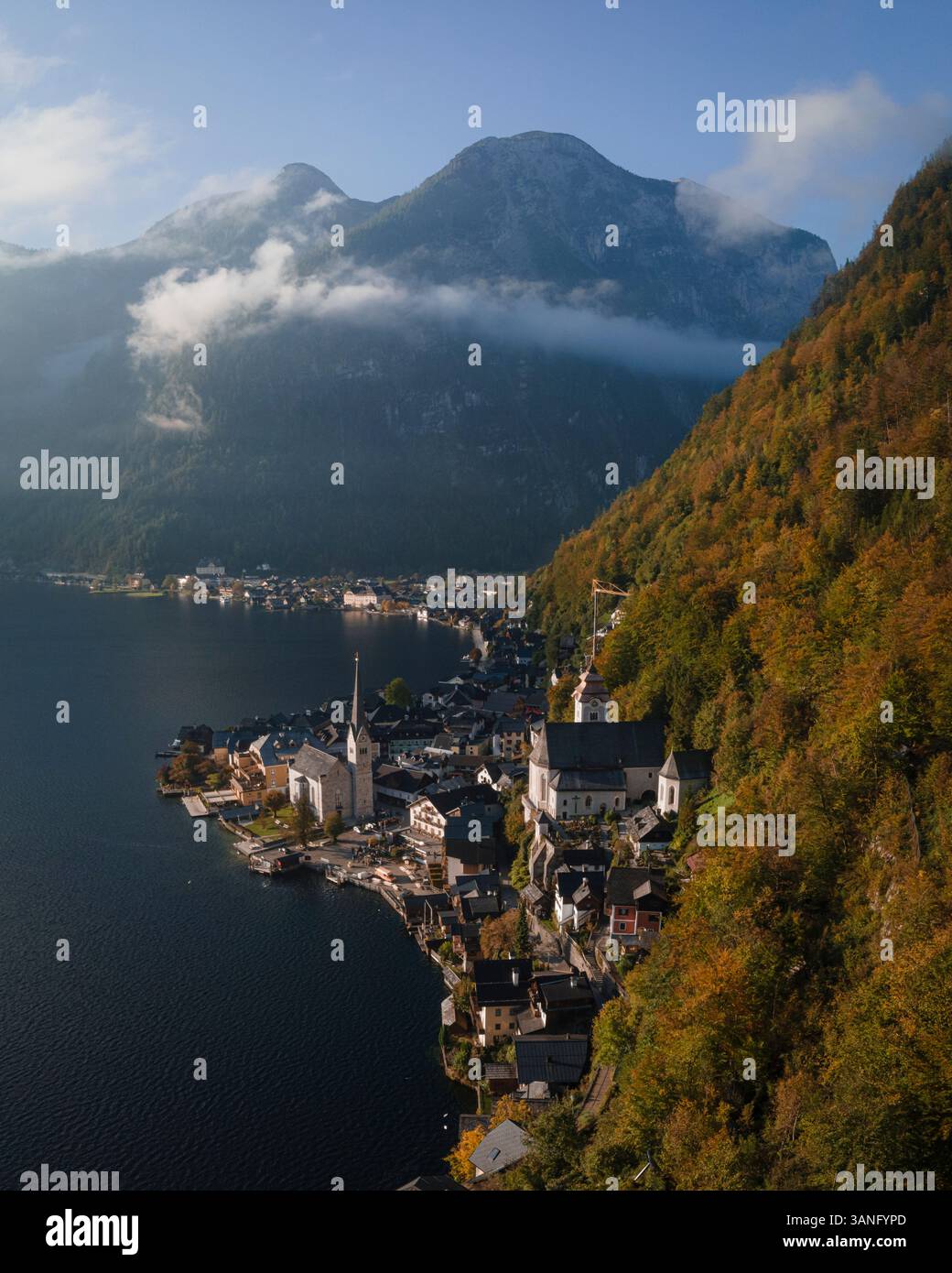 Aerial view of the picturesque town of Hallstatt by the serene Hallstatter See with snow-capped mountains at sunrise, Upper Austria, Austria. Stock Photo