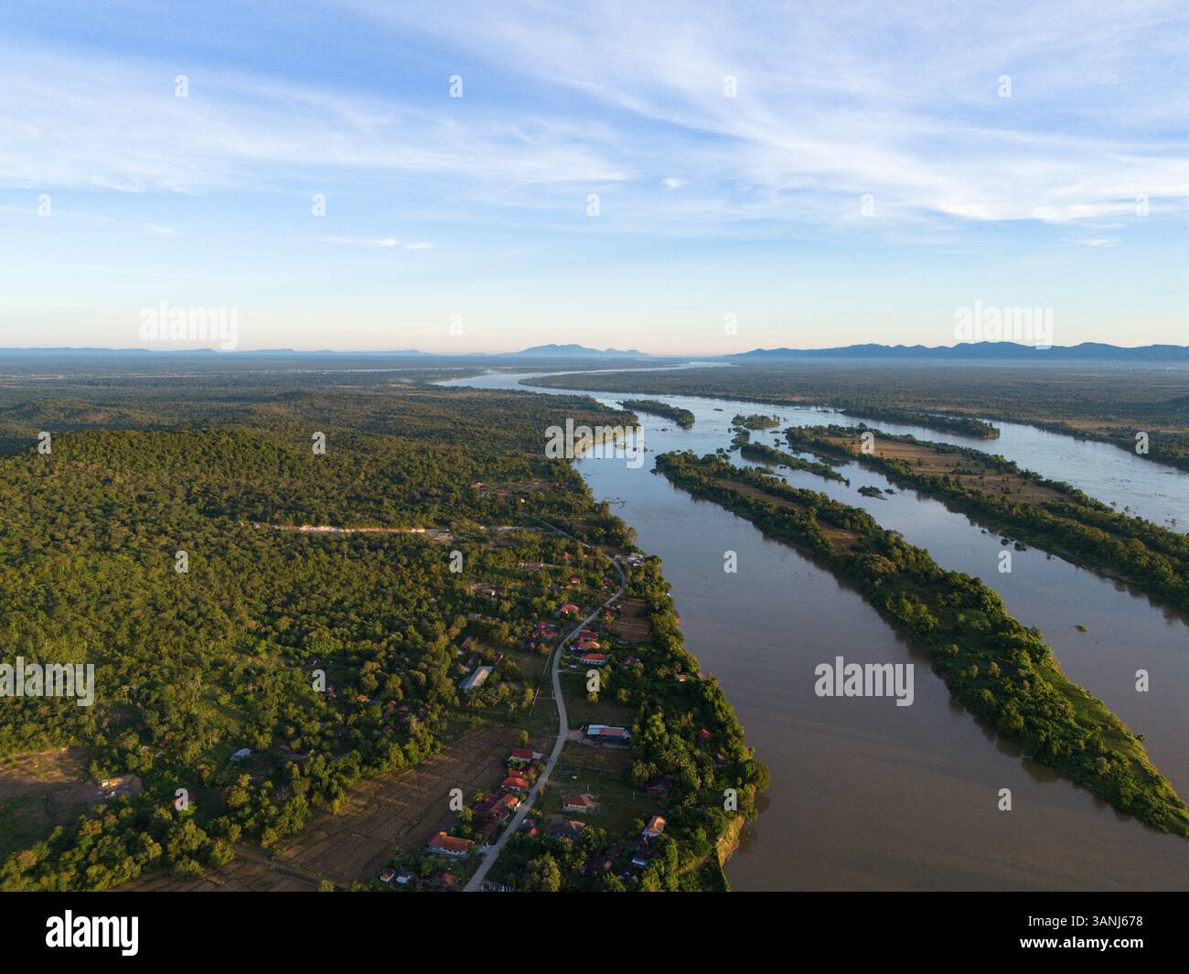 Aerial view of a meandering river surrounded by lush forests and ...