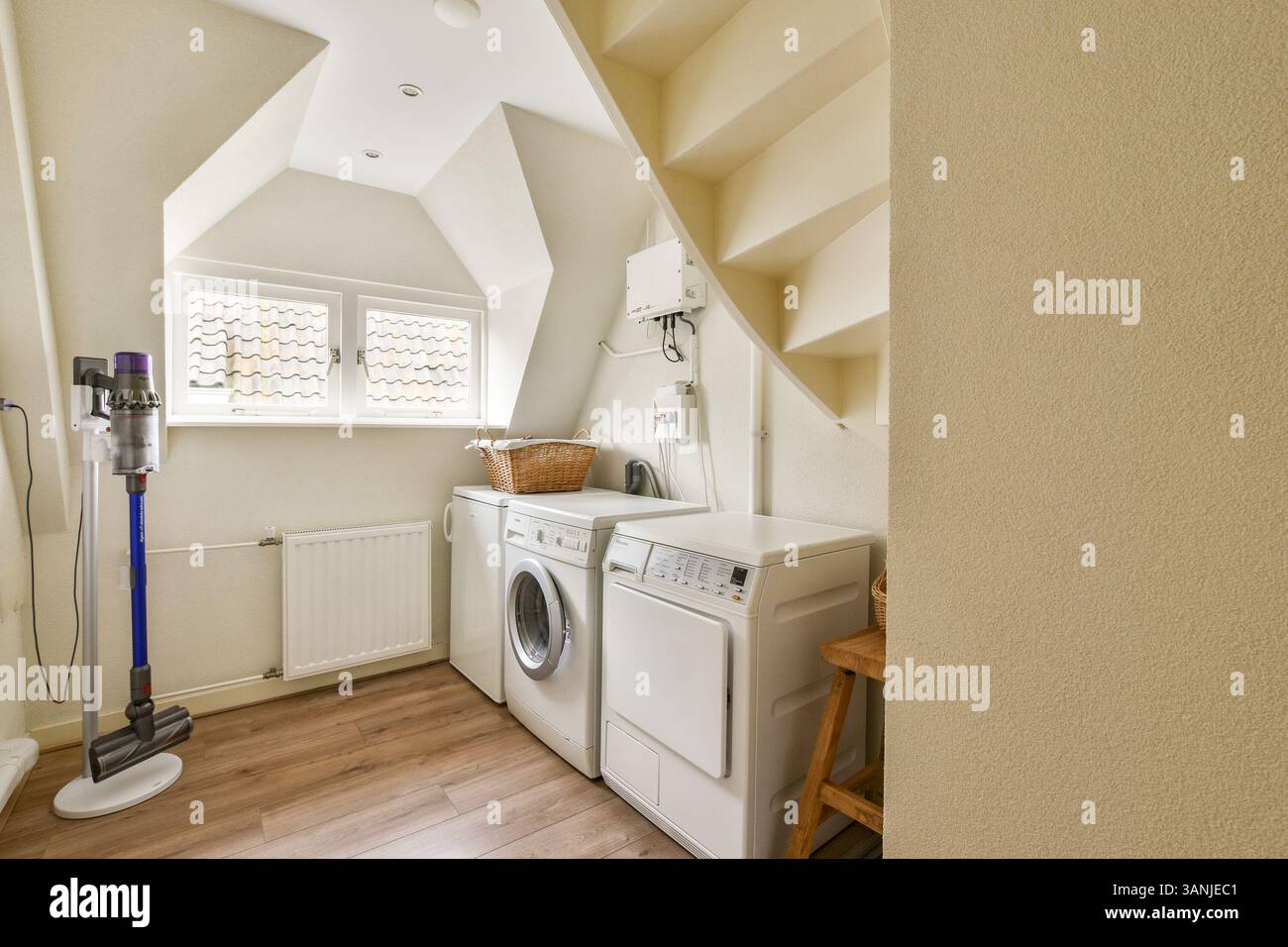 A stylish and efficient laundry room featuring a washing machine, dryer