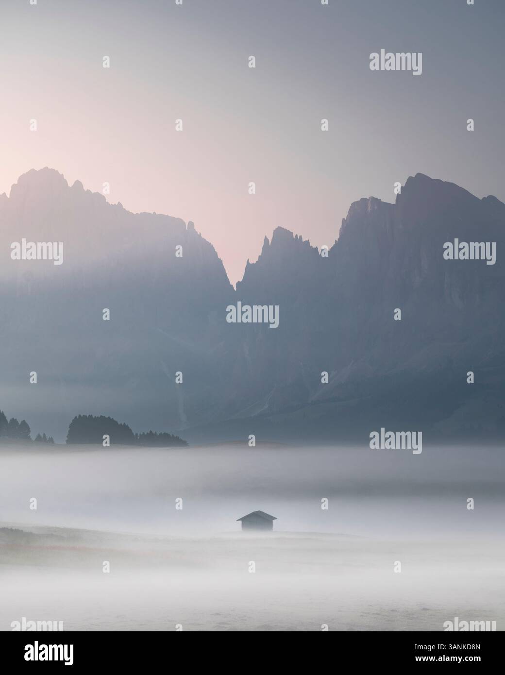 Aerial view of misty mountains with a tranquil cabin in a serene valley ...