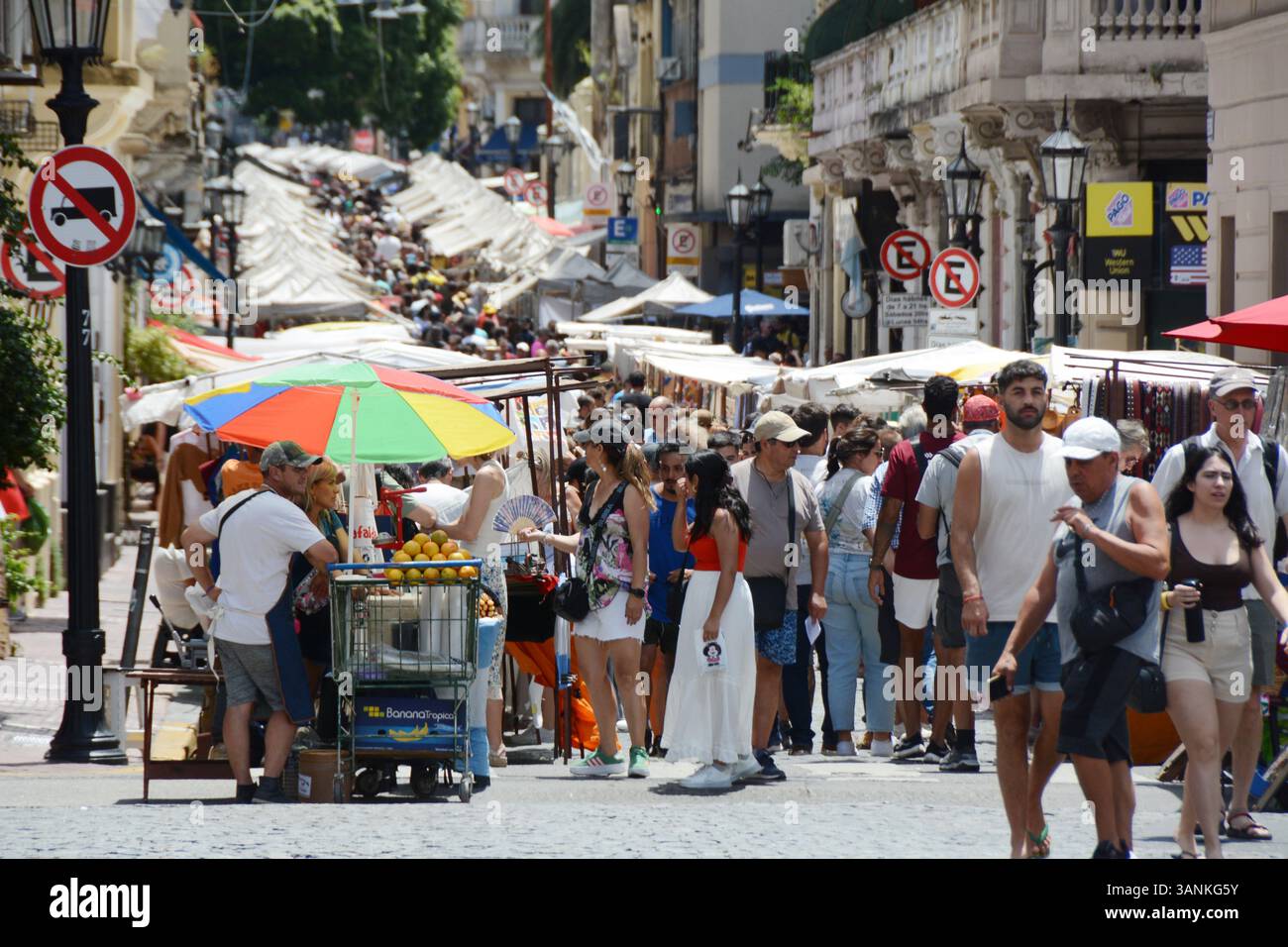 Tourists shopping from artisans at the San Telmo Sunday market and street fair on Defensa Street, in Buenos Aires, Argentina. Stock Photo