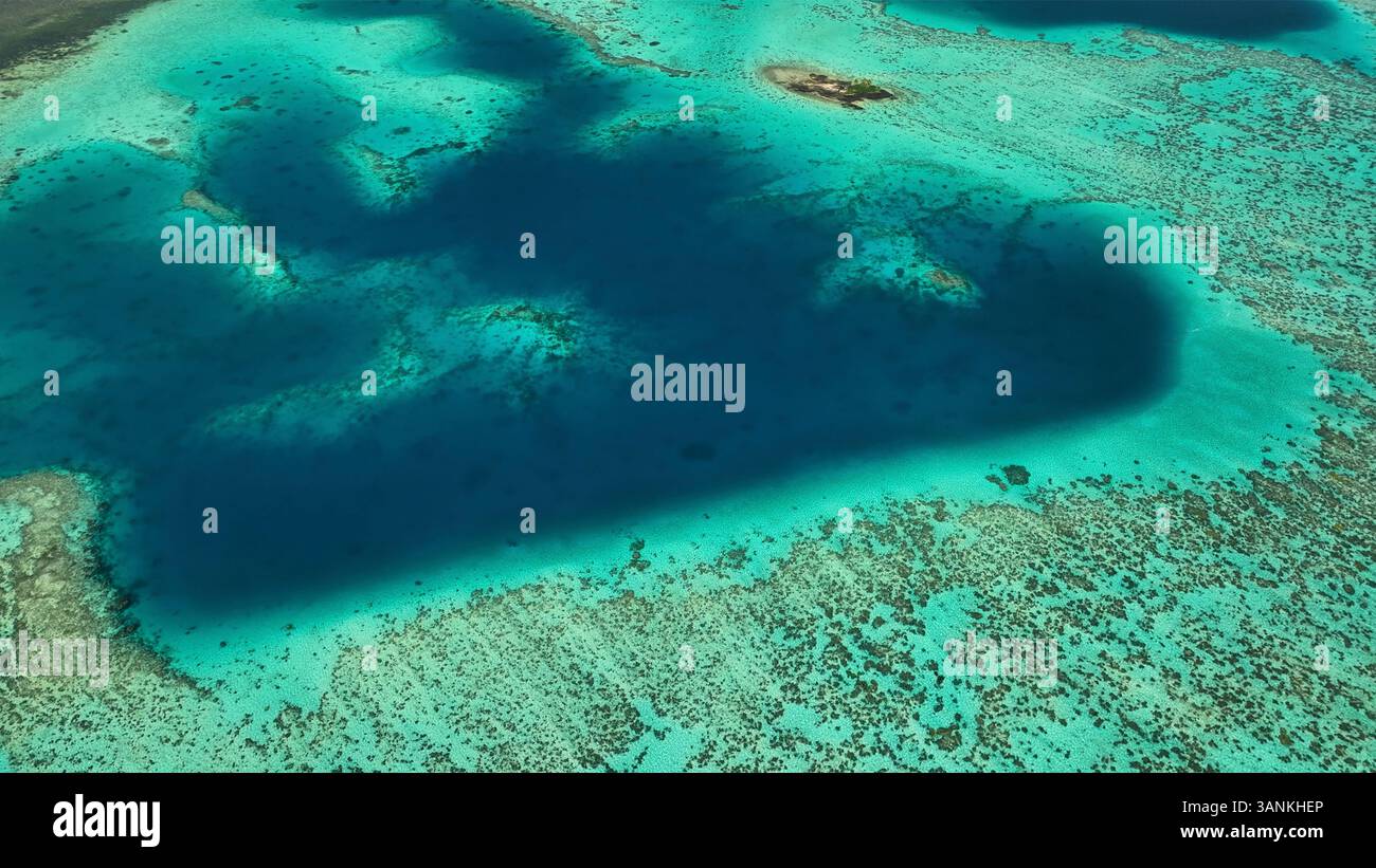 Aerial view of a beautiful tropical island with a pristine reef and ...