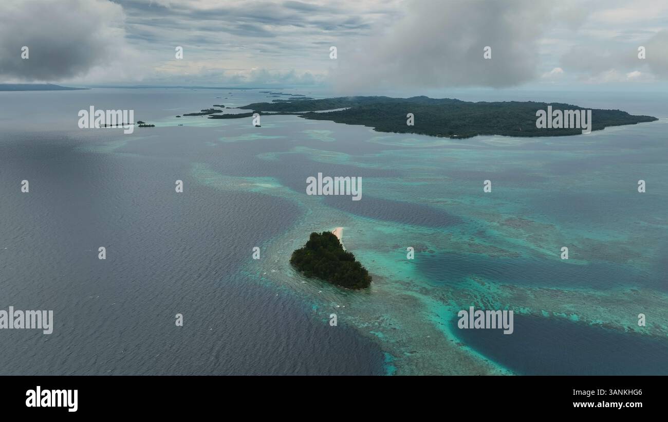 Aerial view of a tropical paradise island with clear water and coral ...