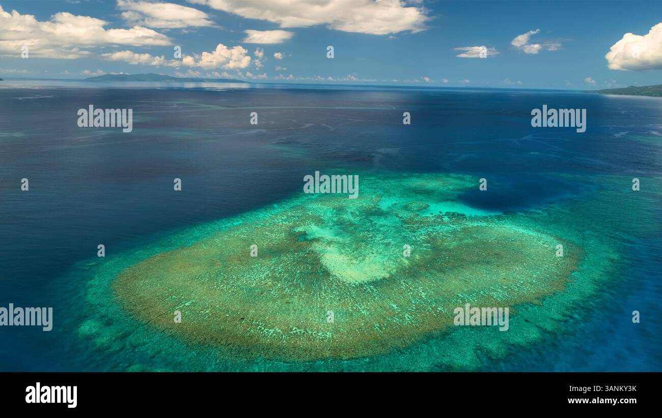 Aerial view of tropical island with reef and clouds, Fiji Stock Photo ...