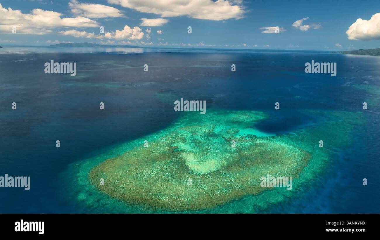 Aerial view of tropical island with reef and clouds, Northern Fiji ...