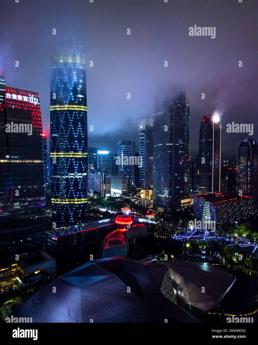 Aerial view of illuminated skyscrapers and city lights in a bustling ...