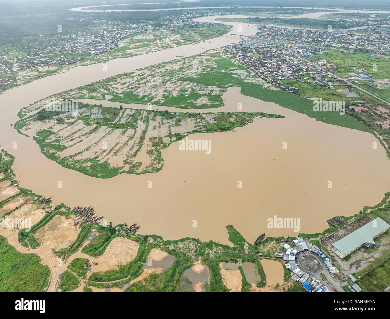 Aerial view of serene lake surrounded by lush greenery and wetlands ...