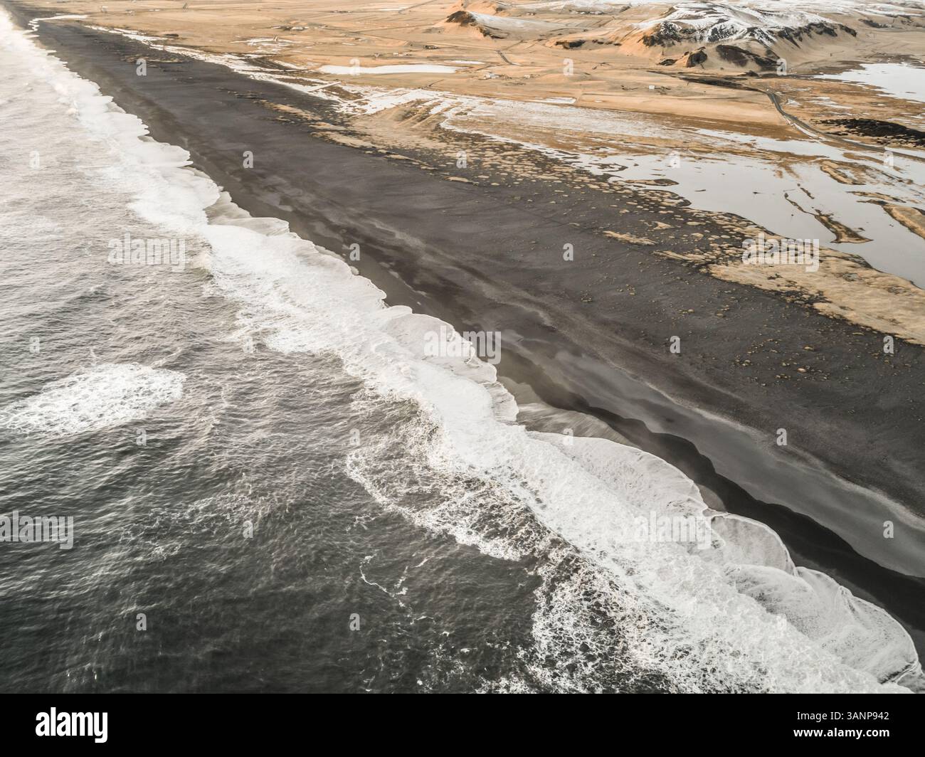 Aerial view of Dyrhólaey peninsula with the black sand on the beach in ...