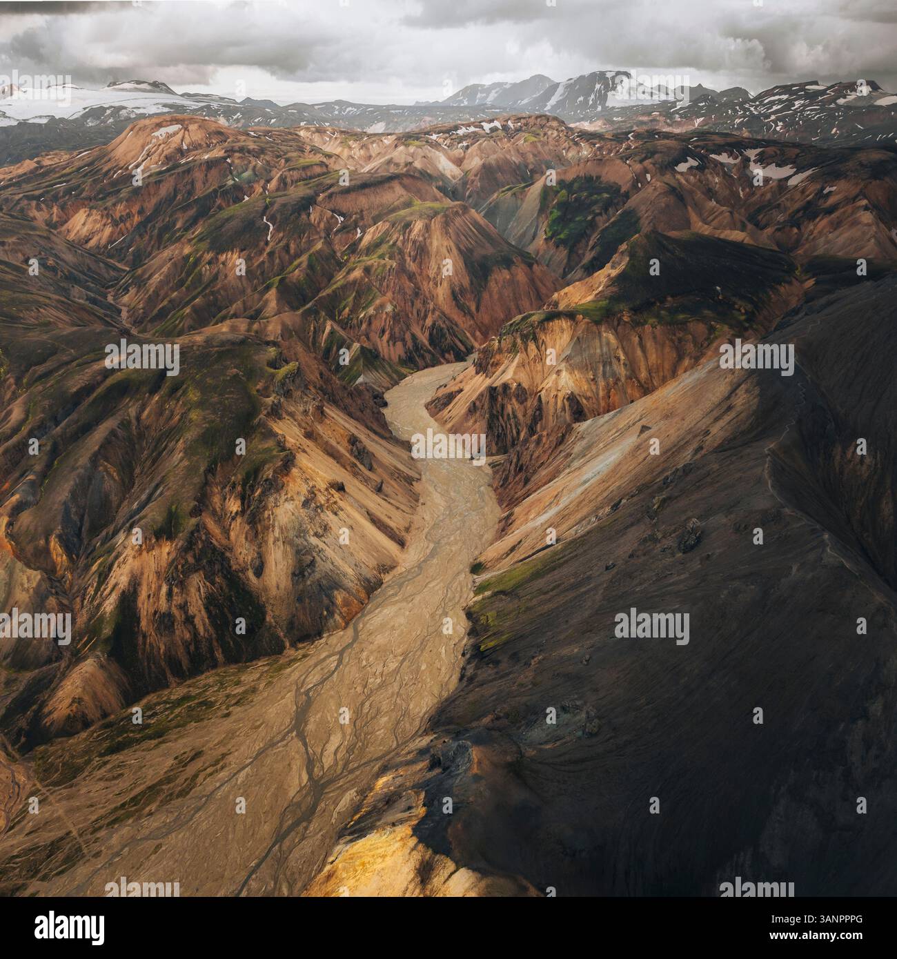 Aerial view of colorful volcanic rock formations and rugged mountains ...