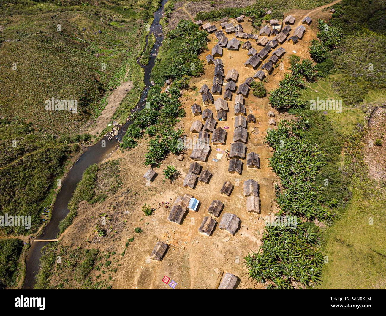 Madagascar Rual Aerial view of remote village with thatched roofs and river in rural ...