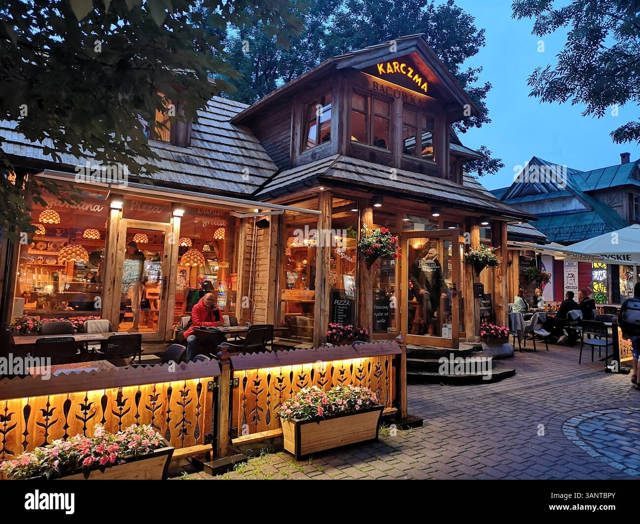 Karczma Bacówka in Zakopane is a picturesque wooden tavern and restaurant. Wooden architecture of Zakopane Krupowki Street southern Poland. - Smartphone Captured Stock Image