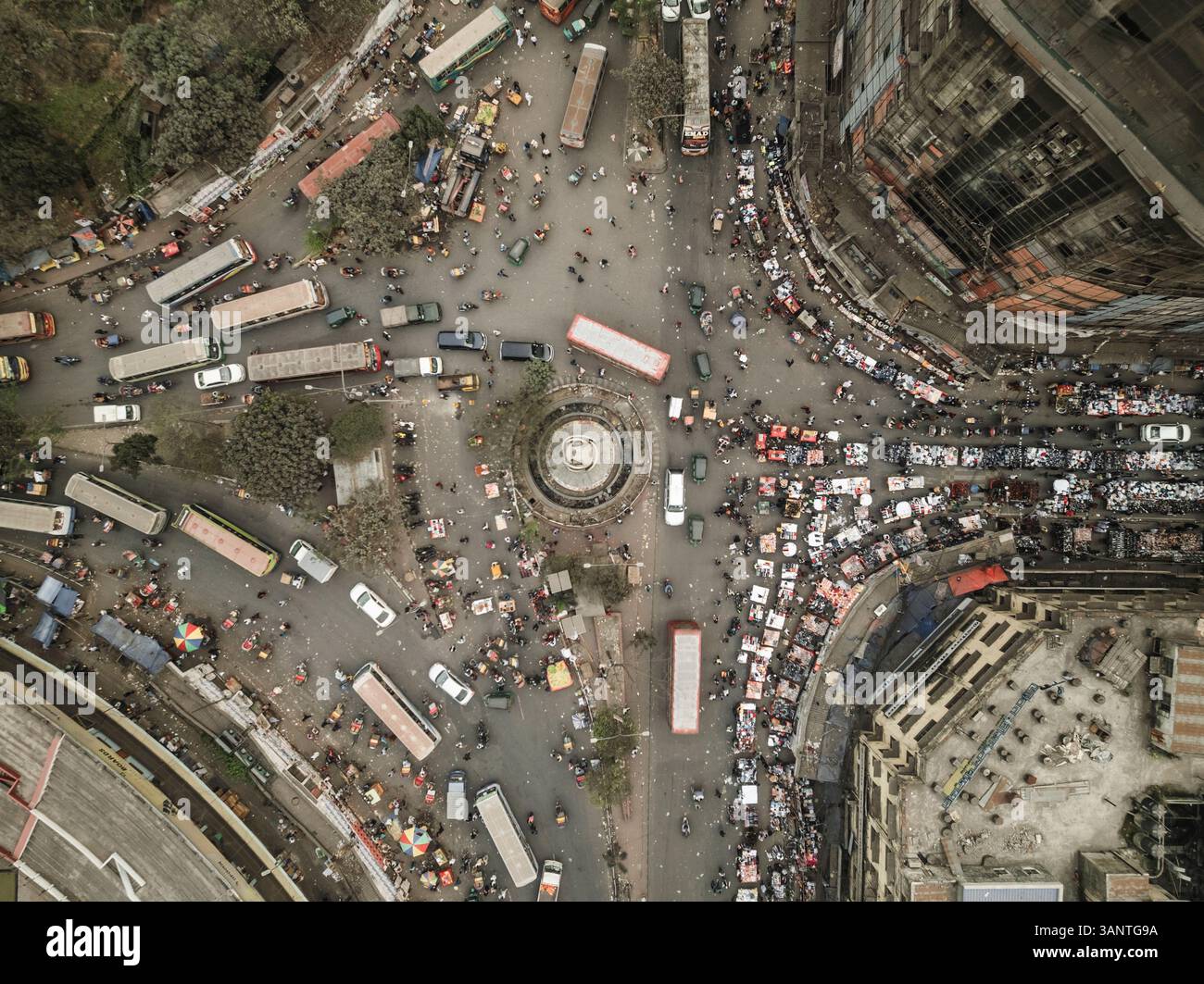 Aerial view of a bustling roundabout filled with vehicles and people in ...