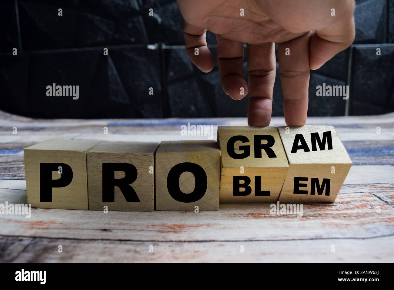 Concept word Solving a problem and making program and changes the word problem to program on wooden blocks on a wooden table Stock Photo