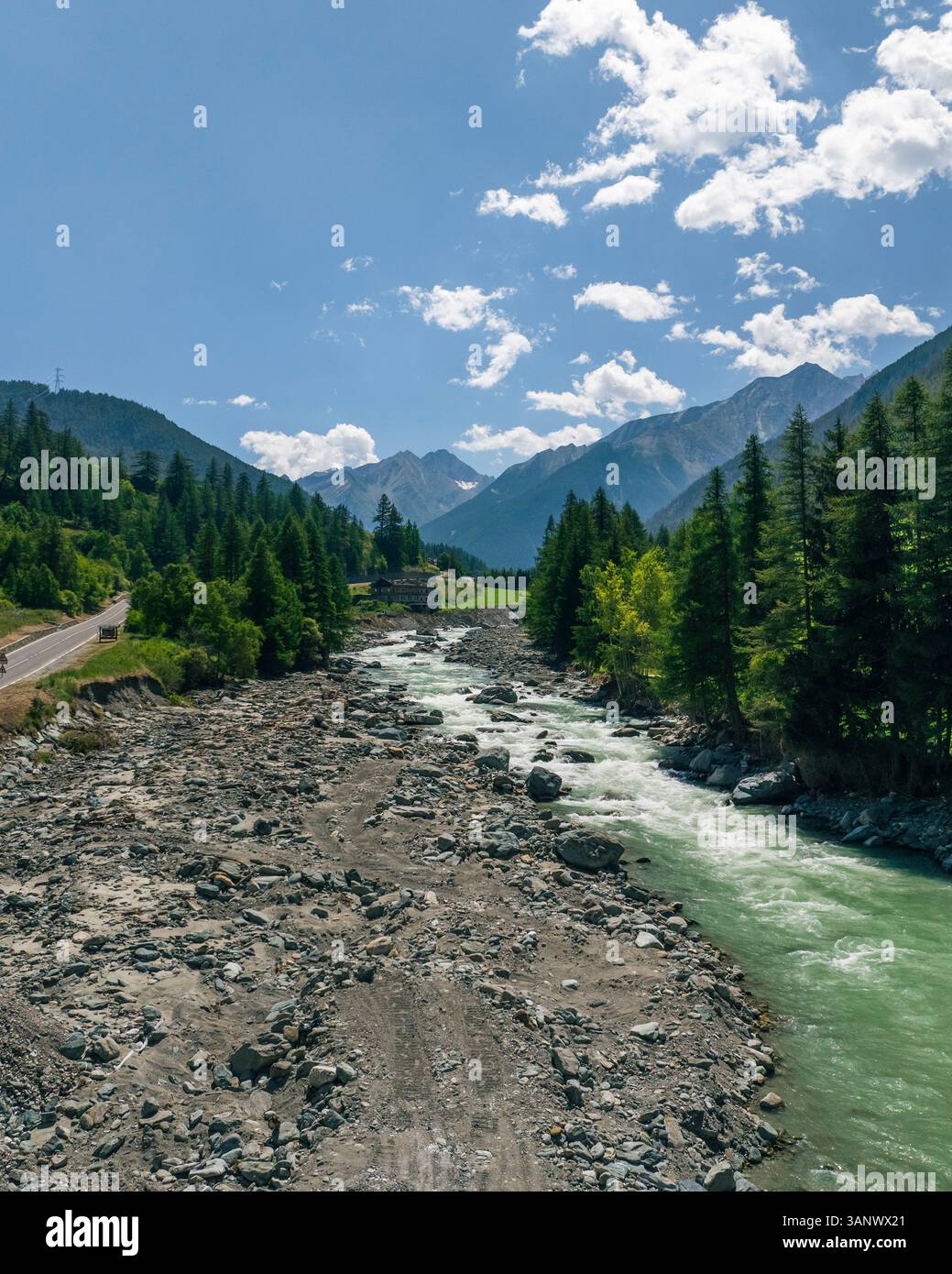 The Alps Rivers Aerial view of majestic alps with a winding road and serene river ...