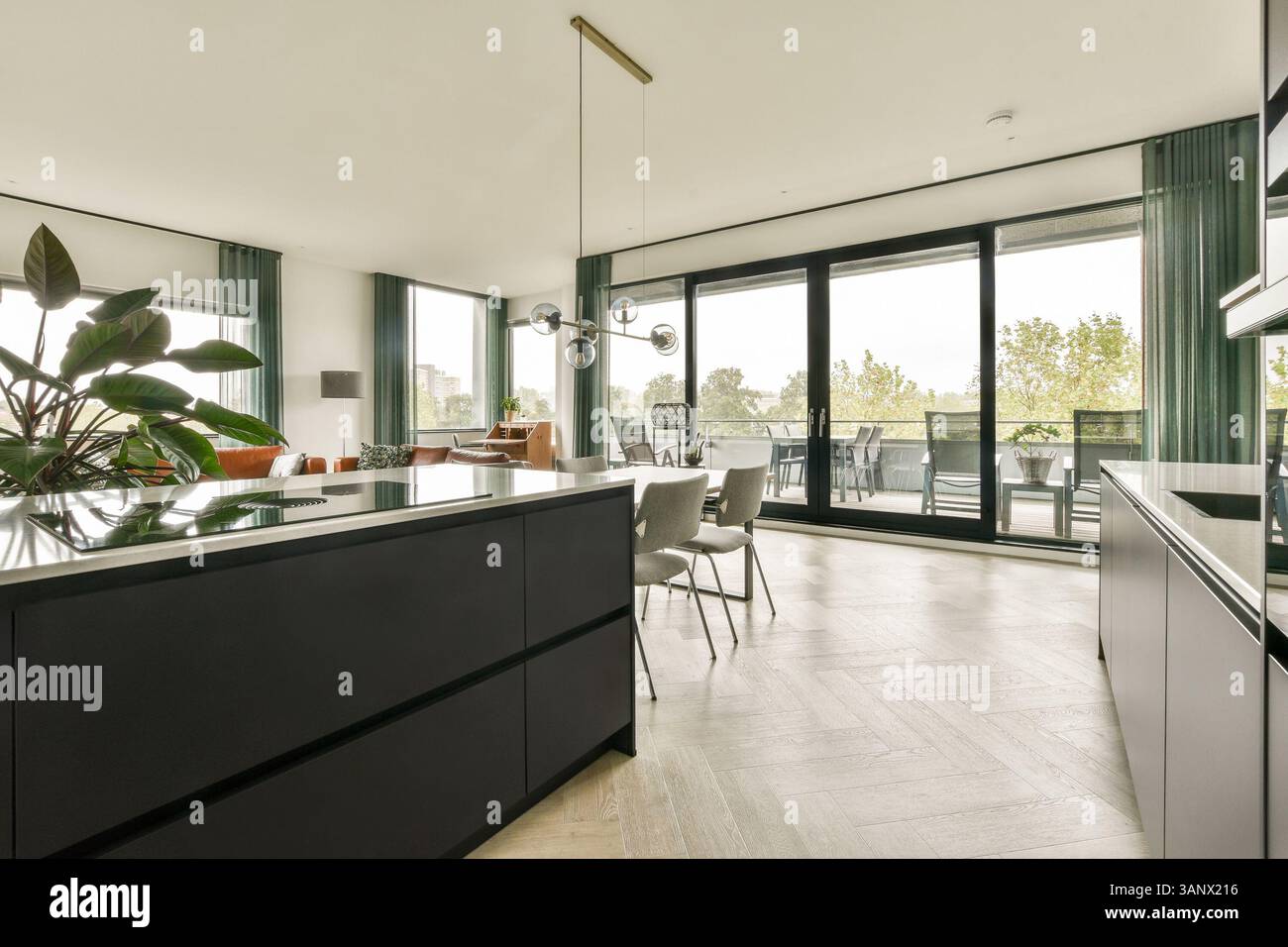 A sleek and contemporary kitchen featuring elegant furniture, large ...