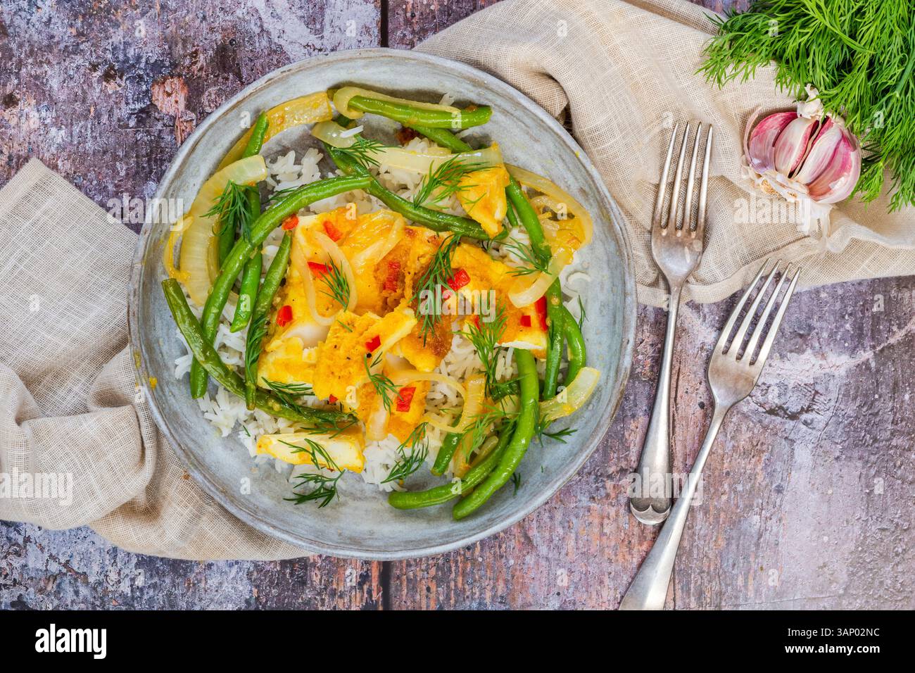 Ginger and turmeric cod with green beans and rice Stock Photo