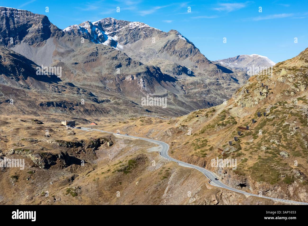 aerial-view-of-winding-mountain-pass-road-through-majestic-alpine