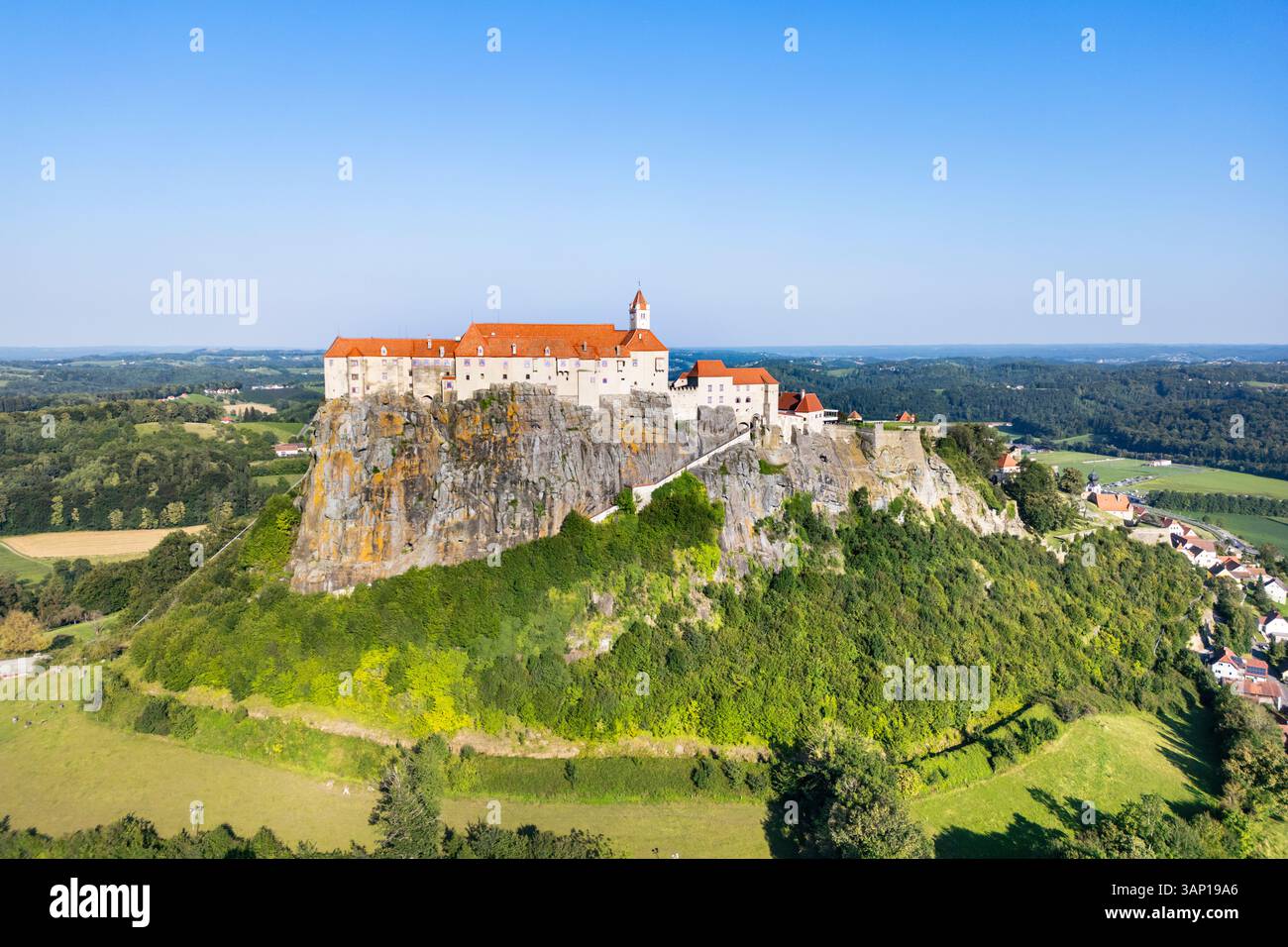 Aerial view of a beautiful medieval castle on a hilltop surrounded by ...