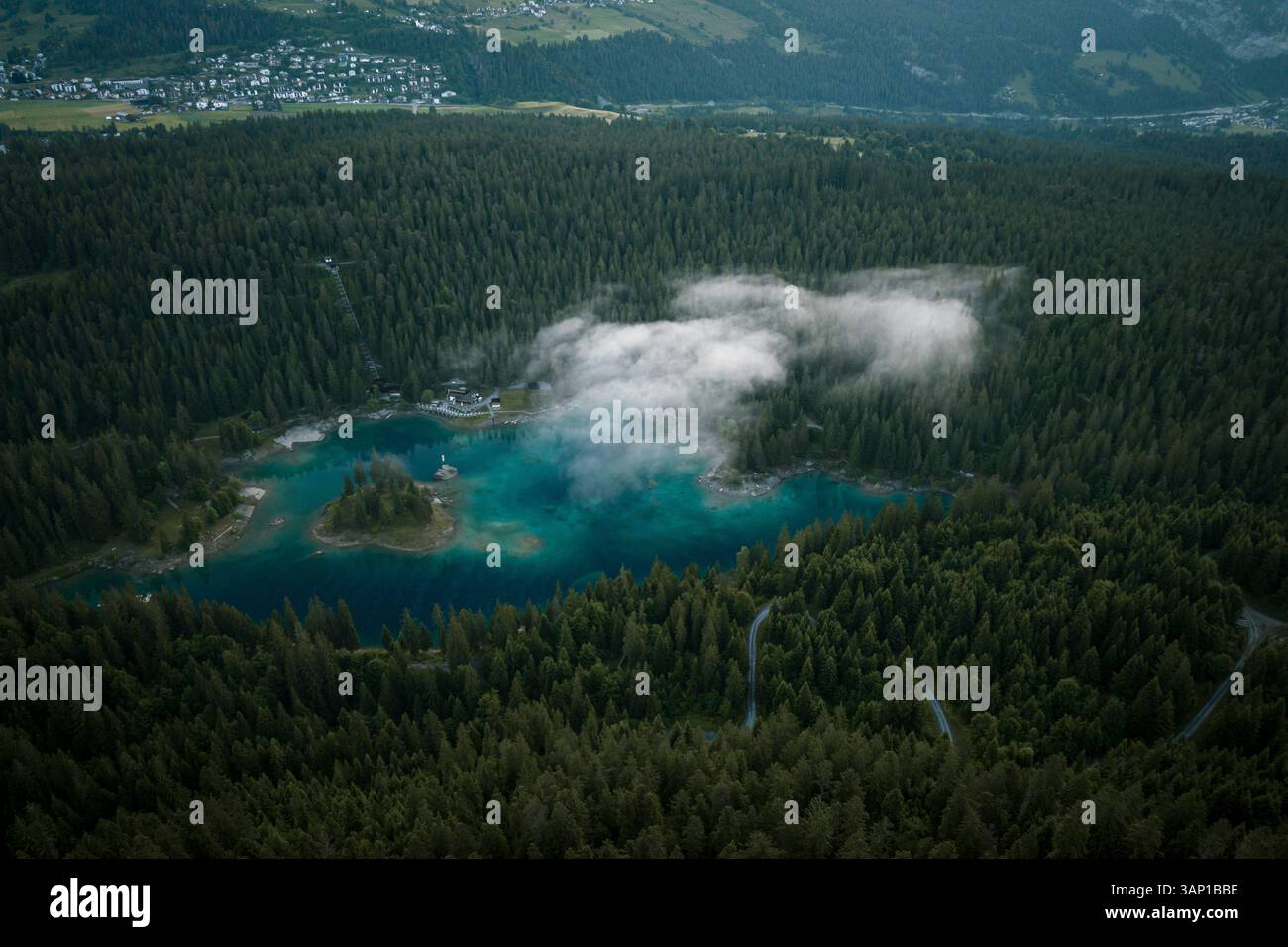 Aerial drone view a clear water lake covered in fog, Eibsee, Flims ...