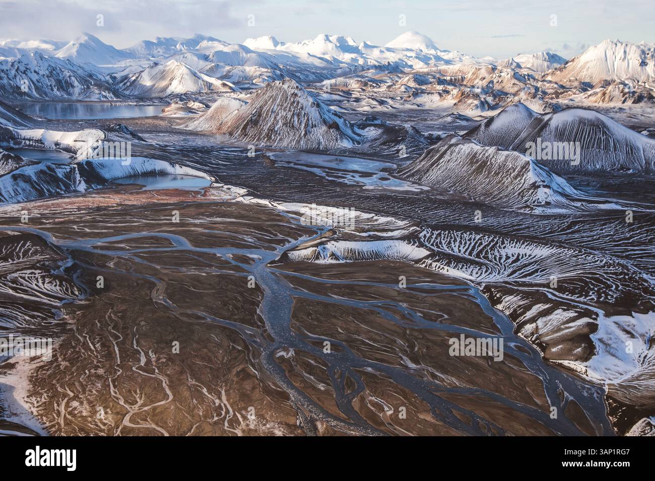 Snow trapped in between lower breaks in the mountain create a memorizing visual effect, Iceland. Stock Photo