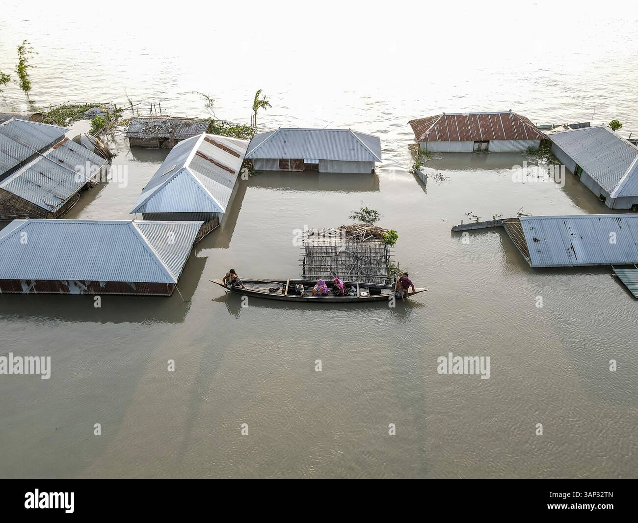 Aerial view of submerged homes and boats amidst flood water in a rural ...