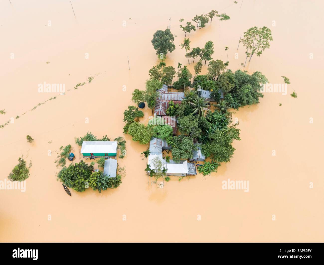 Aerial view of a flooded village with submerged houses and trees ...
