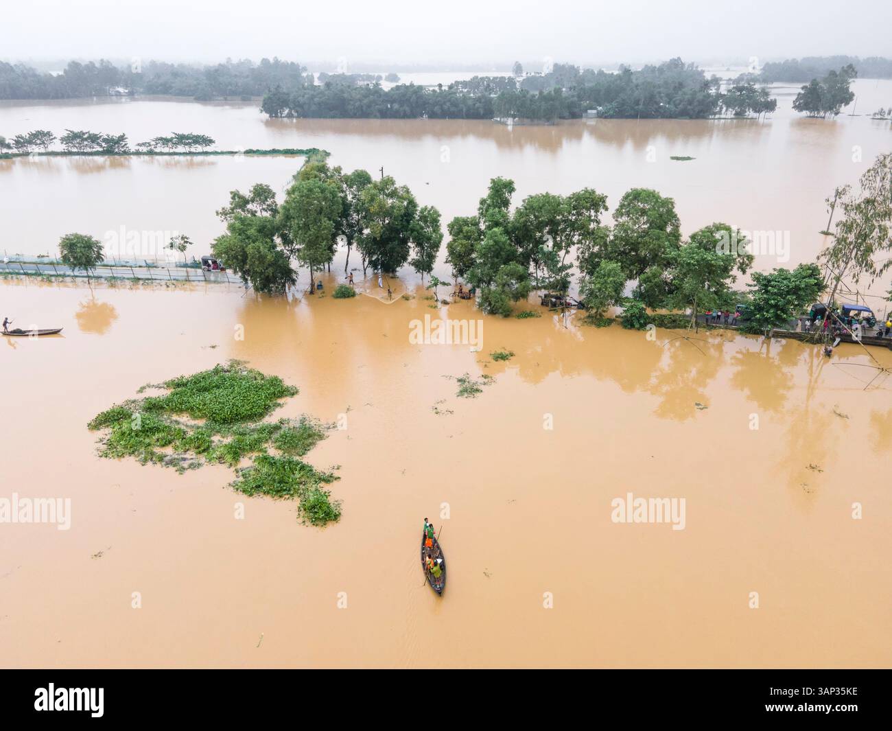 Aerial view of a flooded village with submerged houses and trees ...